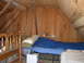 1995 Ford Bronco - Interior view of an attic space converted into a sleeping area with multiple beds and wooden paneling.