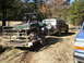 1995 Ford Bronco - A 1992 Ford Bronco is parked next to a utility vehicle on a trailer in a wooded area.