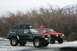 1990 Chevrolet Suburban - Two modified Jeep Cherokees parked in a snowy, wooded area with mountains in the background.