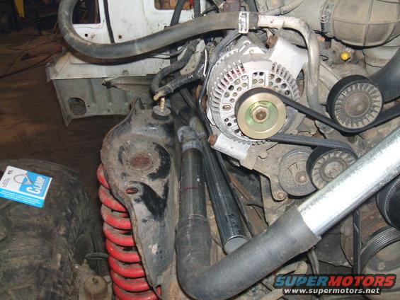 1995 Ford Bronco engine compartment with alternator, belts, and red coil springs