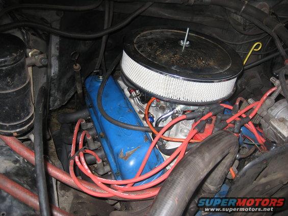 Engine bay with blue valve covers, chrome air cleaner, and red spark plug wires
