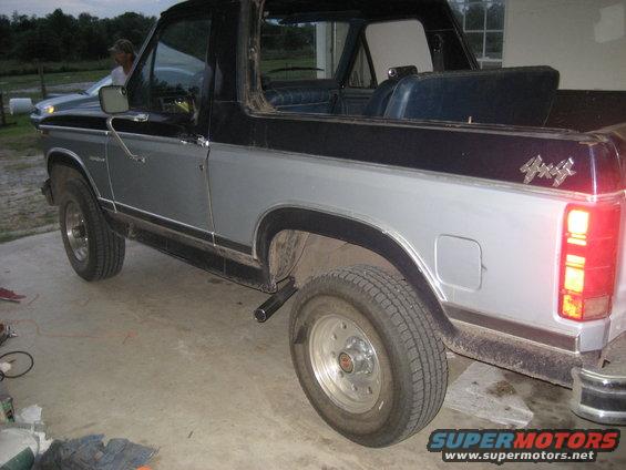 Silver and black Ford Bronco with a 4x4 badge, seen from the rear three-quarter angle