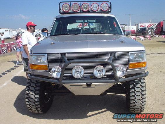 Front view of a modified 1992-1996 Ford Bronco with a custom bumper and light bar