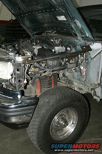 1986 Ford Bronco engine bay with hood open, showing engine components and front wheel well