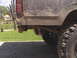 1980 Dodge Magnum - Rear view of a weathered pickup truck, focusing on the taillight and suspension components.