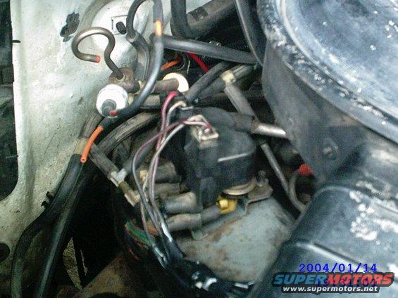 Engine distributor cap with wires and hoses
