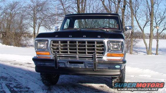 Black 1979 Ford F-150 front view in snow, chrome grille, chrome bumper