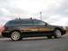 2002 Volkswagen Passat - A black station wagon is parked on asphalt under a cloudy sky, reflecting the sunset.
