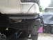 1989 Ford Bronco - Close-up of a vehicle's undercarriage, focusing on a winch mount and frame structure.