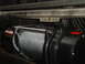 1989 Ford Bronco - Close-up of a winch and its steel cable, mounted beneath a vehicle's frame.