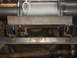 1989 Ford Bronco - Close-up view of a winch and its mounting bracket on the underside of a vehicle.