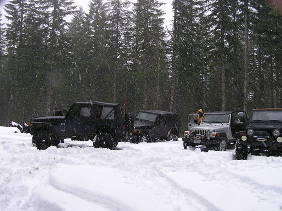 Silver Jeep Wrangler in snow, front view. 2005 model