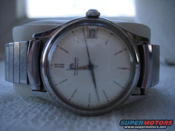 Watch with white face, date window, and metal band