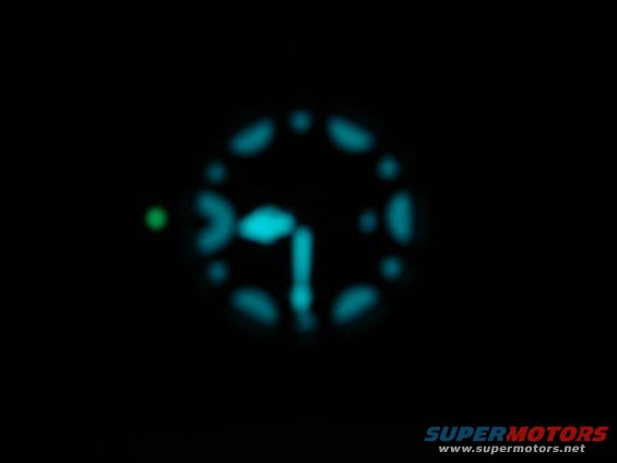 Blurred dashboard gauge cluster with blue and green lights