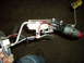 1991 Ford Bronco - A person is holding a vehicle's fuel pump assembly, which includes a float and various hoses and electrical connections.