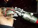 1991 Ford Bronco - A hand holds a fuel pump assembly with attached hoses and wires, with a red end visible.