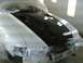 1997 Ford Mustang - A white car with a black hood is being worked on, with protective coverings visible.