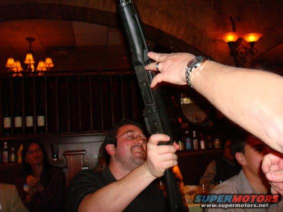 man holding shotgun indoors