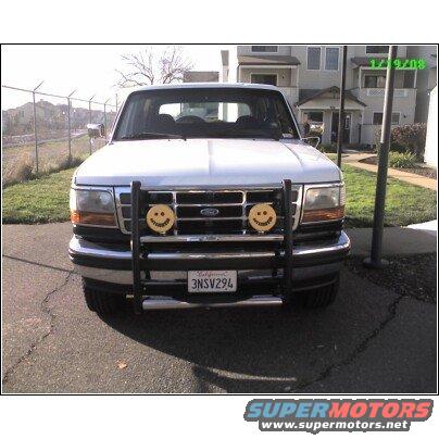 1995 Ford Bronco front end with bull bar, California license plate 3NSV294, and two yellow smiley face fog lights