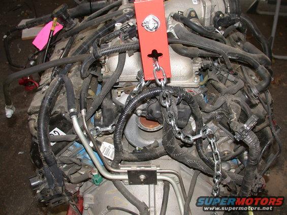 Engine with chains and red lifting bracket
