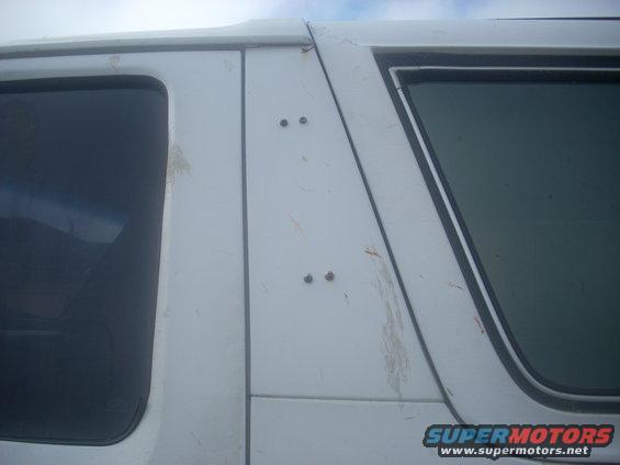 White SUV side panel showing two windows and rivets