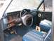 1982 Ford Bronco - Interior view of a vintage truck, showing the dashboard, steering wheel, and patterned seats.