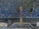 1996 Ford Bronco - Close-up view of a side step bracket mounting bolt, likely on the undercarriage of a vehicle.
