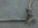1996 Ford Bronco - Close-up of a rusted metal pipe with a flange, possibly a component from a vehicle or industrial equipment.