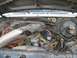 1982 Ford Bronco - The engine bay of a 1982 Ford Bronco is visible, with the hood open, revealing the engine components and wiring.