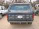 1982 Ford Bronco - Rear view of a dark blue Ford Bronco with an Arizona license plate, parked next to a white SUV.