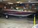 1988 Ford Bronco - A boat is parked on a trailer inside a garage, with shelves and equipment visible in the background.