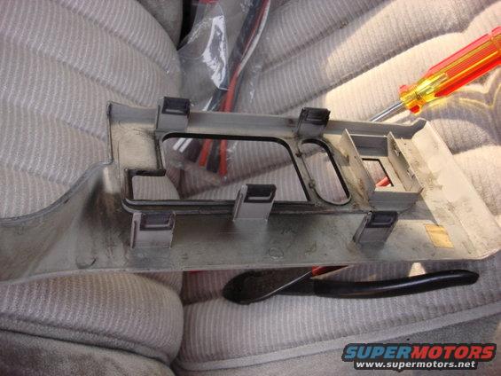 radio75.jpg here is the switch trim panel. it is held in by 5 friction pins. i used a trim panel and worked them out and the panel came right out.