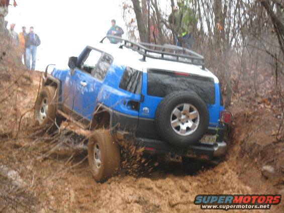 I walked back, took the picture of the white Jeep, then walked back to the obstacle to get this picture of the FJ guy still whaling on his junk...