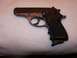 1993 Ford Bronco - A close-up view of a semi-automatic pistol resting on a textured surface.