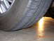 1995 Ford Taurus - Worn tire tread visible on a concrete surface, timestamped 11.30.2007.
