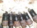 1996 Ford Bronco - A collection of old spark plugs, showing signs of wear and corrosion.