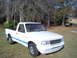 1993 Ford Ranger - This pickup truck has a distinctive grille and headlight design, and blue pinstriping along its side.
