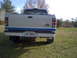 1993 Ford Ranger - Rear view of a white 1993 Ford Ranger pickup truck, a blue stripe along the tailgate and a Georgia license plate.