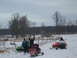 1995 Ford Bronco - A group of people with their snowmobiles in a winter landscape.