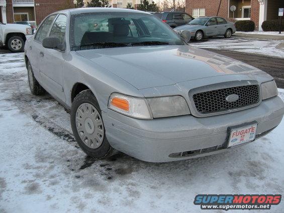 Silver 2004 Ford Crown Victoria parked on a snowy street