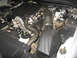 2004 Ford Crown Victoria - The engine compartment of a 2004 Ford Crown Victoria is visible, with the V8 engine, air intake, and associated components clearly depicted.