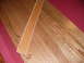 1988 Ford Bronco - Wood flooring is shown with a red carpeted edge and a strip of wood trim.