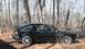1987 Volkswagen Scirocco - Side view of a black 1987 Volkswagen Scirocco parked among trees in a wooded area.
