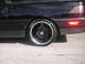 1989 Ford Probe - Close-up of a black car's rear wheel and fender area, aftermarket rims and a 'Turbo' badge.