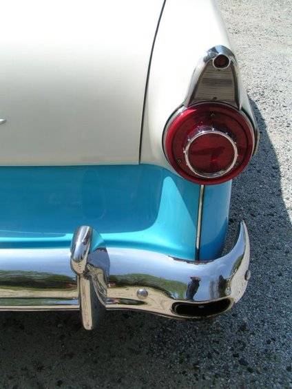 Close-up of a 1956 Ford Fairlane's rear, showing the chrome bumper and round taillight
