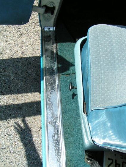 1956 Ford Fairlane interior door sill and light blue patterned seat