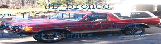 Red 1989 Ford Bronco with a 2" lift, fender flares, custom bumper, and extra lights