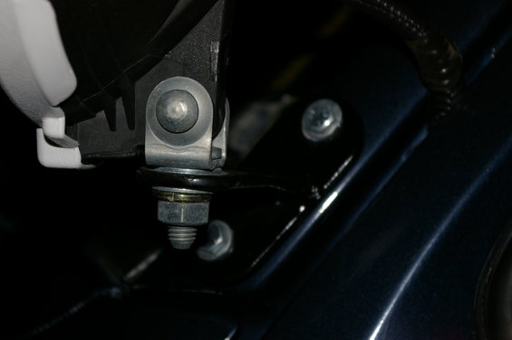 Close-up of a metal mounting bracket with a bolt and nut assembly