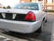 2004 Ford Crown Victoria - Rear view of a silver 2004 Ford Crown Victoria, showing its taillights and trunk panel.