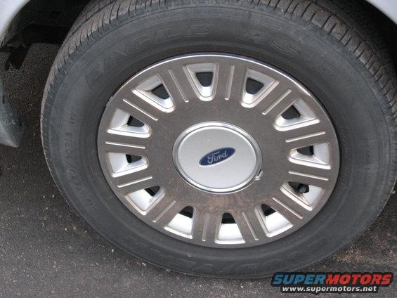 Close-up of a Ford wheel with a silver hubcap and a blue Ford logo